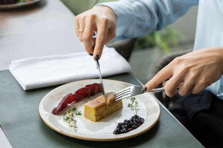 Custard pudding caramelized dessert served in the restaurant, hands eating