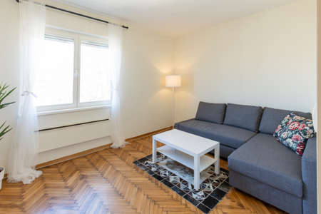 Interior of a living room with old wooden parquet floorの写真素材