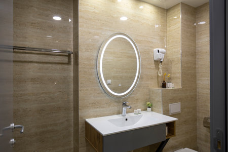 Interior of a luxury hotel bathroom with beige marble wallsの写真素材
