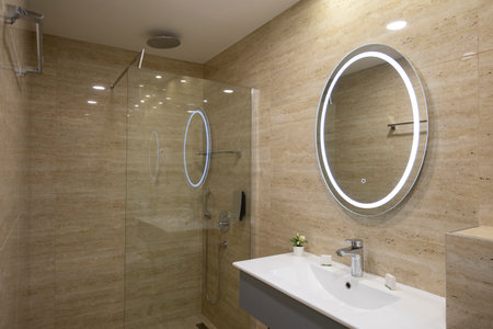 Interior of a luxury hotel bathroom with beige marble wallsの写真素材