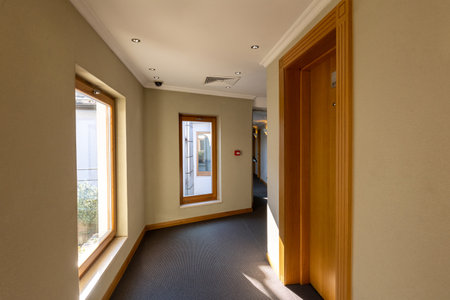 Interior of a hotel corridor with doors with room nummbersの写真素材