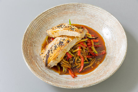 Salmon served with cooked vegetablesの写真素材