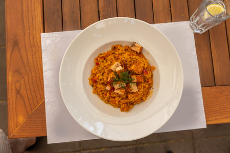 Risotto served in white plate on a restaurant table, top viewの写真素材