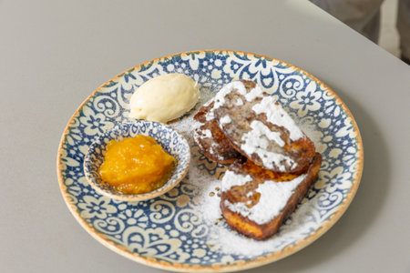 French toast served with peach jam and sugarの写真素材