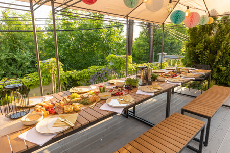 Food served outdoor on a long tableの写真素材