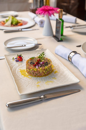 Raw salmon with avocado served in the restaurantの写真素材