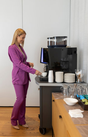 Business woman preparing coffee in the officeの写真素材