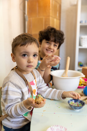 Kids showing food they made by themselves in the montessori kindergarten, banana cookiesの写真素材
