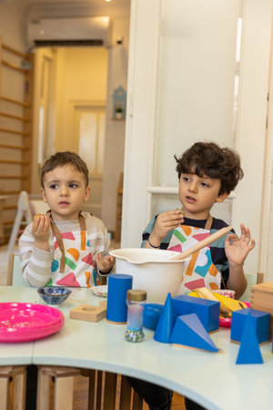 Kids prepering food in the montessori  kindergarten,  banana cokiesの写真素材