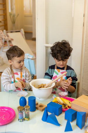 Kids prepering food in the montessori  kindergarten,  banana cokiesの写真素材