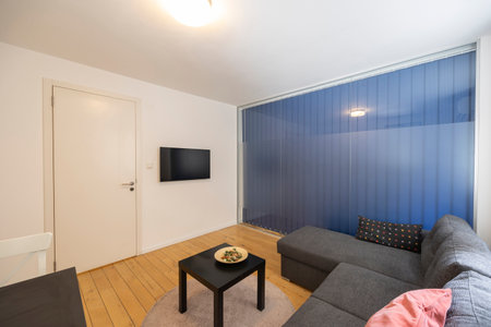 Interior of a living room with glass wall separating from bedroomの写真素材