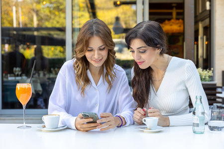 Girlfriends looking man on a phone dating appの写真素材