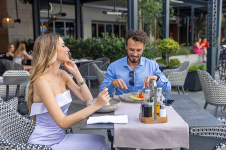 Happy couple having lunch at the outdoor restaurant gardenの写真素材