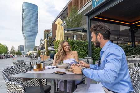 Happy couple having lunch at the outdoor restaurant gardenの写真素材