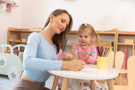 Mother draws with her toddler childの写真素材