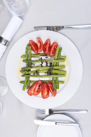 Top view of caprese salad with asparagus served on a plateの写真素材