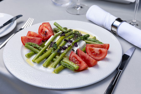 Caprese salad with asparagus served on a plateの写真素材