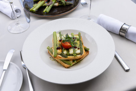 Roasted asparagus with cheese on a toast breadの写真素材