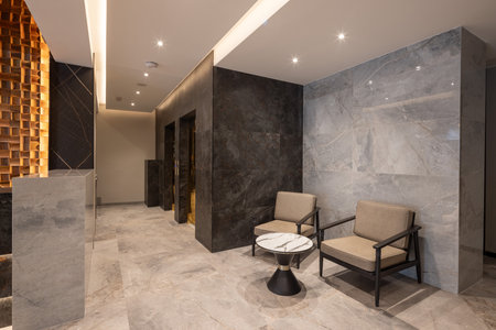 Marble desk at the hotel reception, waiting area with two armchairsの写真素材