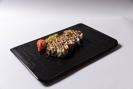 Salmon skin sushi roll served on a black stone, top viewの写真素材