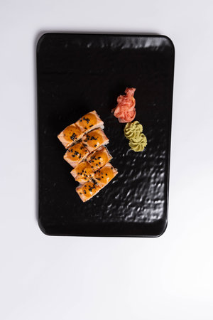 Salmon skin sushi roll served on a black stone, top viewの写真素材