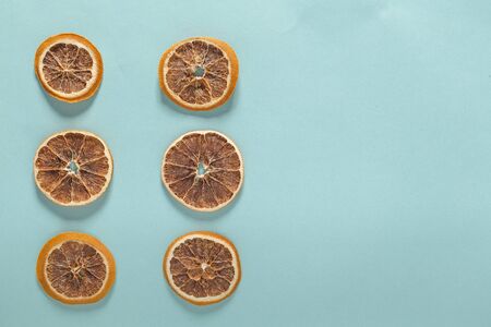 six dried orange slices isolated top view on blue backgroundの写真素材