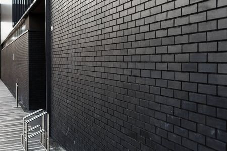 Dark grey brick wall with blured background. copy spaceの写真素材