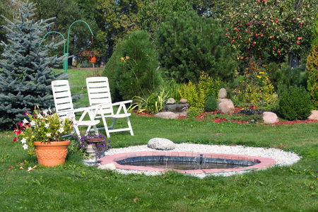 Garden with chair and flowerpot in the middle of the gardenの写真素材
