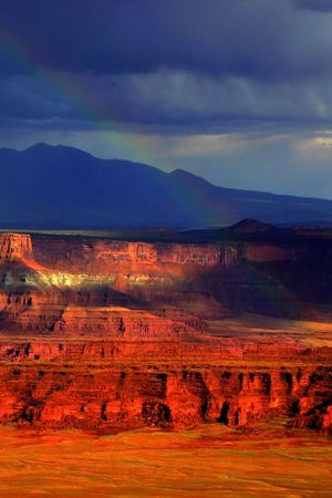 Rainbow and dark stormy skies during a storm in Canyonlands, Utah.の写真素材