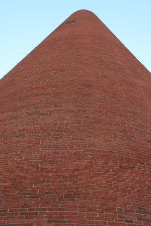 Red Brick Shot tower towering in Baltimore, Maryland, near Little Italyの写真素材