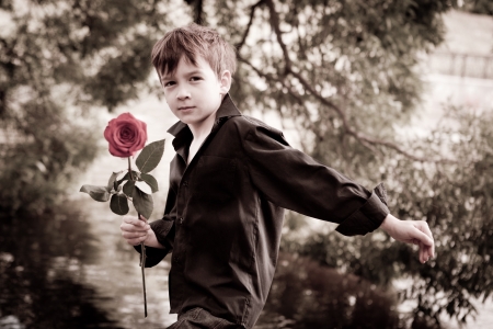 Boy with rose in his handの写真素材