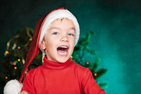 Happy small child in santa hatの写真素材