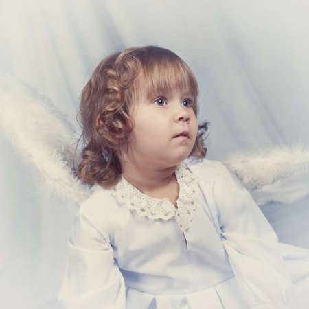 Thoughtful nice girl with wings, christmasの写真素材