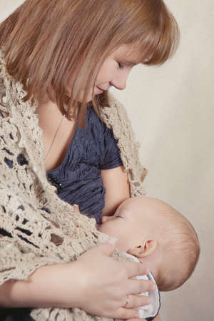 Woman breast feeding baby, indoor