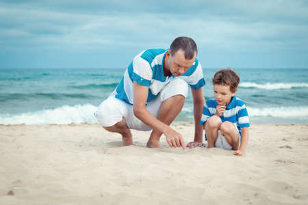 father and son walking on beach, outdoorの写真素材
