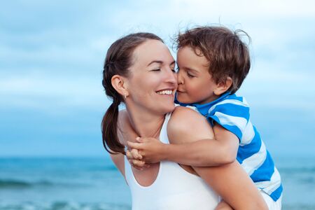 Portrait of happy mother and son at sea, outdoorの写真素材
