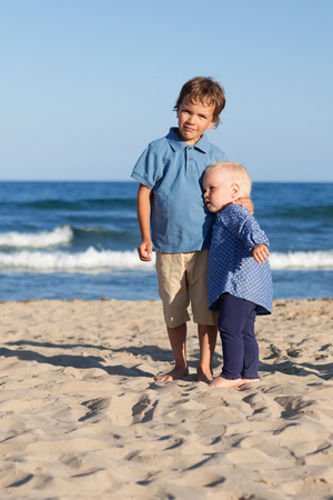 Brother and sister on walk near sea, outdoorの写真素材