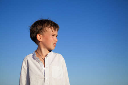 Portrait of kid on background of blue skyの写真素材