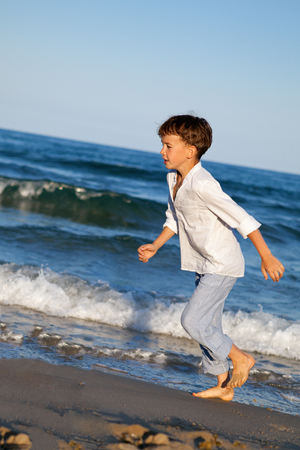 Happy child are running on beach, outdoorの写真素材