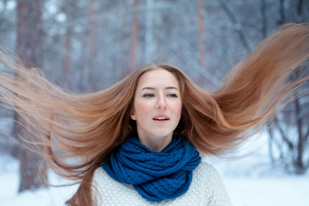 Portrait of beautiful girl in winter parkの写真素材