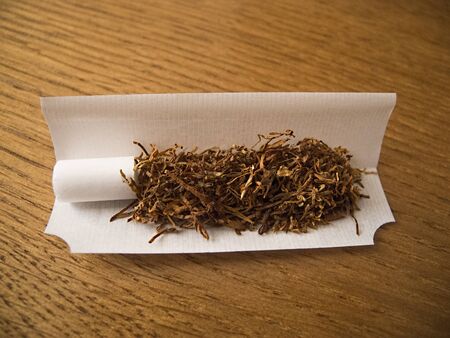Tabacco in paper with filter, ready for rollingの写真素材