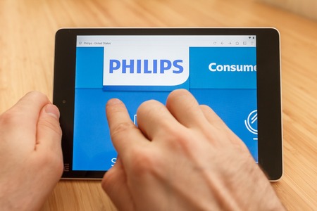 SAN FRANCISCO, US - 1 April 2019: Close up to hands holding tablet using internet and looking through Philips web site, in San Francisco, California, USA. An illustrative editorial imageのeditorial素材