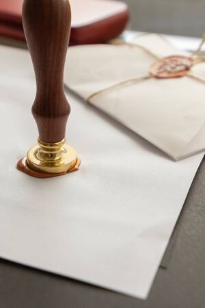 Notary public wax stamper. White envelope with brown wax seal, golden stamp. Responsive design...