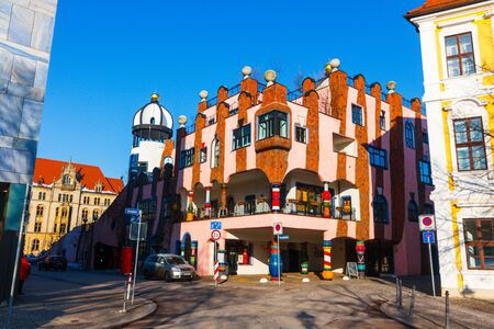 Magdeburg, Germany - 25 February 2019: Colorful building of Hundertwasser art with mosaic. A cafe corner in front of colons of Hundertwasser house Modern architecture of Magdeburg cityのeditorial素材