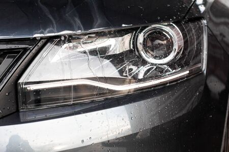 Water drops and foam on the car light in the vehcle wash station. Cleaning automobile concept, underground water pollutionの写真素材