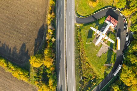 The airliner in the field near the forest. The plane restaurant near the highway surrounded by deciduous trees. Mlada Boleslav, 01.12.2019のeditorial素材