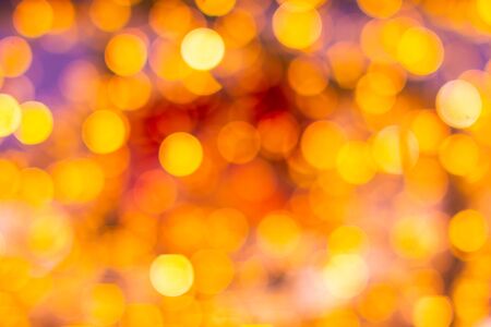Gold yellow and red abstract background with bokeh defocused blurred lights.