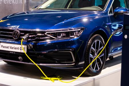 Charging an plug-in hybrid Volkswagen Passat Variant GTE with the power cable supply plugged in,...