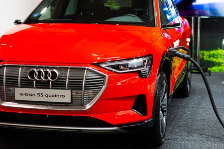 Charging an plug-in hybrid Audi e-tron 55 quattro with the power cable supply plugged in, Prague, Czechia, November 2019のeditorial素材