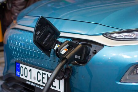 Charging an plug-in hybrid Hyundai Kona with the power cable supply plugged in, Prague, Czechia,...